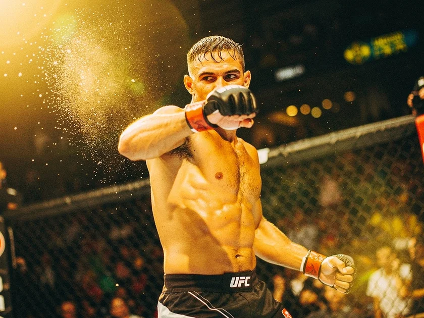 Dricus du Plessis holding the UFC middleweight championship belt after title defense in 2026