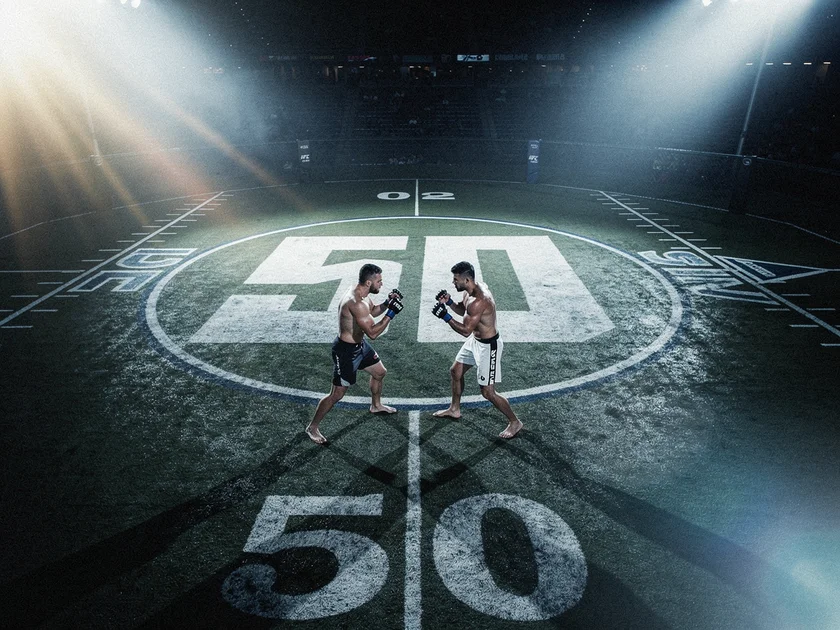 Ilia Topuria raises his fist as UFC featherweight champion after a title fight victory in 2024