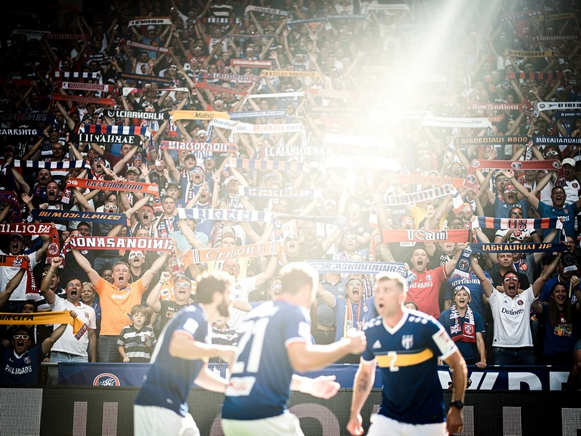 Israel Adesanya in UFC octagon during middleweight title fight, striking pose against opponent