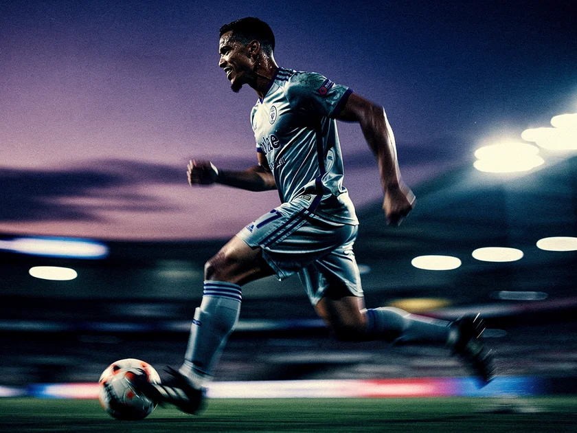 Mohamed Salah in Liverpool kit preparing to take on a defender in a Premier League match