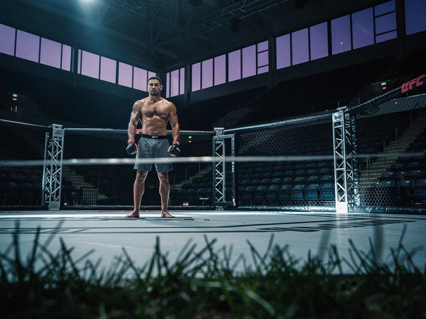 Jon Jones UFC heavyweight champion standing in the octagon with title belt, 2026